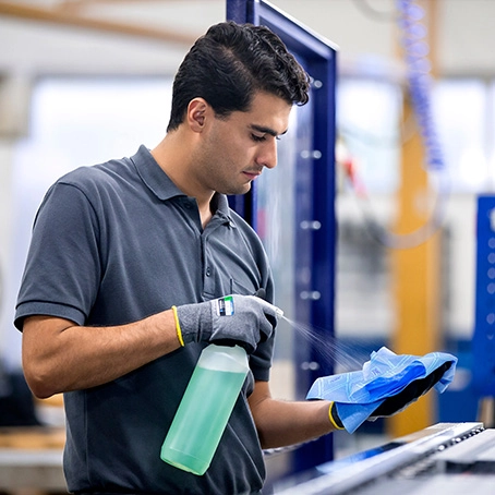 Man spraying onto a microfiber cloth